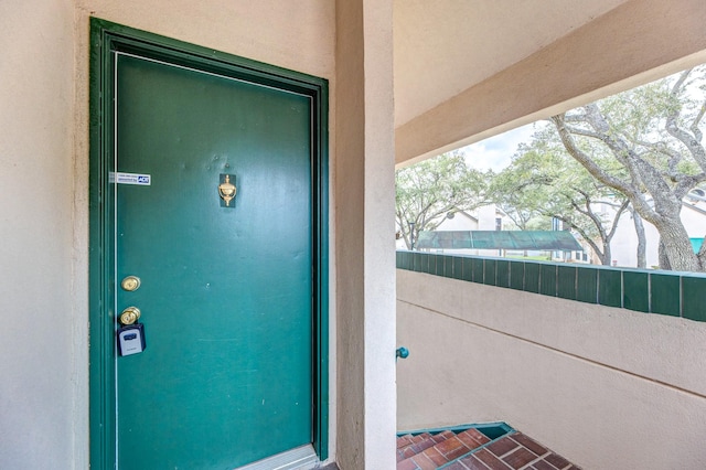 property entrance with stucco siding