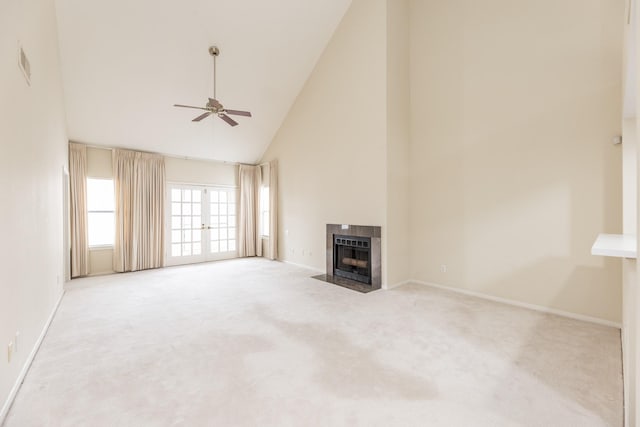 unfurnished living room with ceiling fan, high vaulted ceiling, a fireplace, visible vents, and carpet