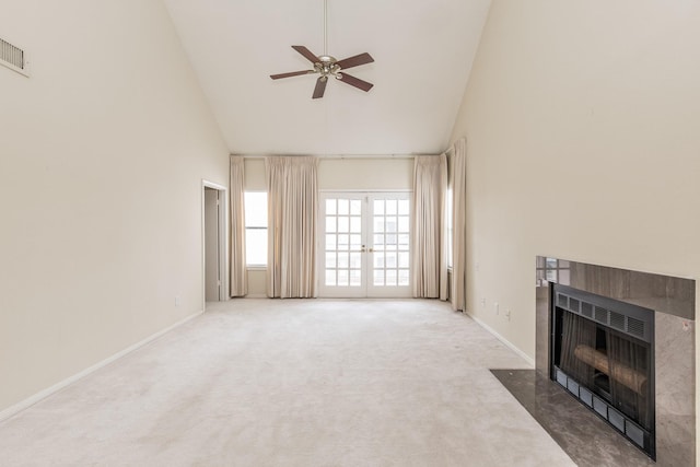 living room with high vaulted ceiling, carpet flooring, a fireplace with flush hearth, a ceiling fan, and baseboards