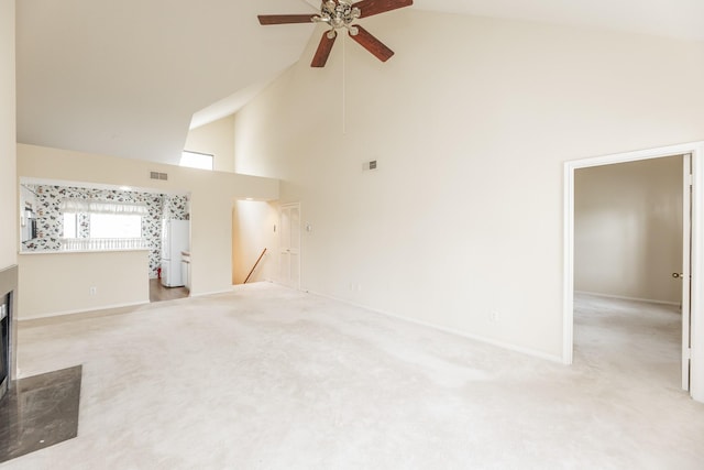 living area with high vaulted ceiling, carpet, visible vents, and a fireplace with flush hearth