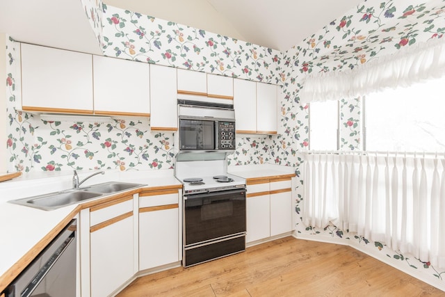 kitchen featuring range with electric stovetop, white cabinetry, a sink, dishwasher, and wallpapered walls