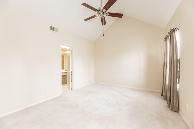 empty room featuring light carpet, baseboards, visible vents, ceiling fan, and vaulted ceiling