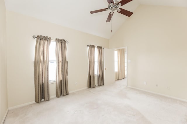 spare room with high vaulted ceiling, carpet flooring, and a healthy amount of sunlight