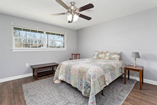 bedroom with ceiling fan, baseboards, and wood finished floors