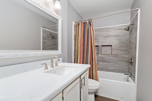 full bathroom featuring shower / bath combo, vanity, toilet, and a textured ceiling