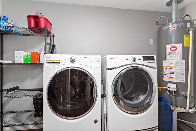 laundry area with laundry area, tile patterned floors, a textured ceiling, washer and dryer, and water heater