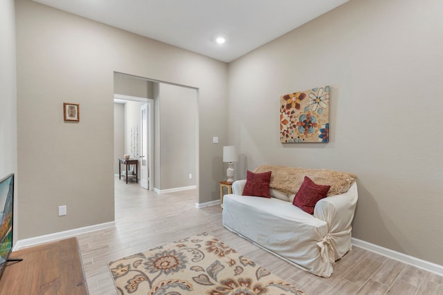 living area featuring light wood-type flooring and baseboards