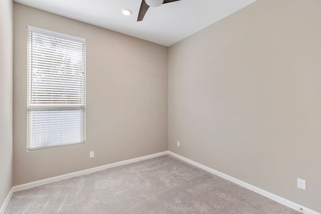 spare room with baseboards, carpet floors, and ceiling fan