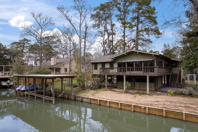 rear view of house featuring stairs and a deck with water view