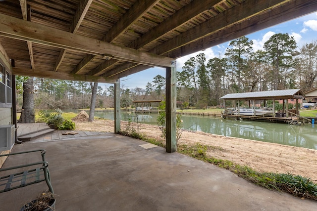 view of patio with a water view and a boat dock