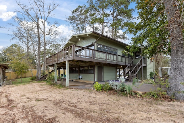 rear view of property with a patio area, fence, stairway, and a deck