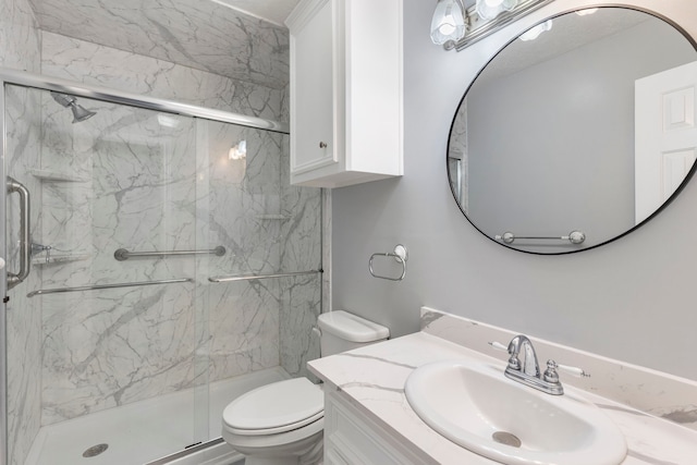 full bath featuring a marble finish shower, vanity, and toilet