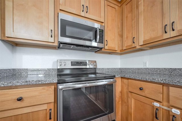 kitchen featuring dark countertops and appliances with stainless steel finishes