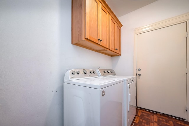 washroom featuring cabinet space and washer and clothes dryer