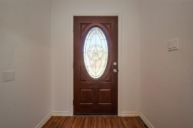 entrance foyer featuring dark wood-type flooring and baseboards