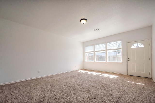 carpeted entrance foyer with baseboards and visible vents