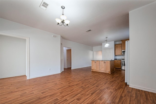 kitchen with dark wood-type flooring, visible vents, and a notable chandelier