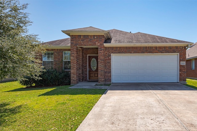 view of front of house featuring driveway, a garage, a shingled roof, brick siding, and a front yard