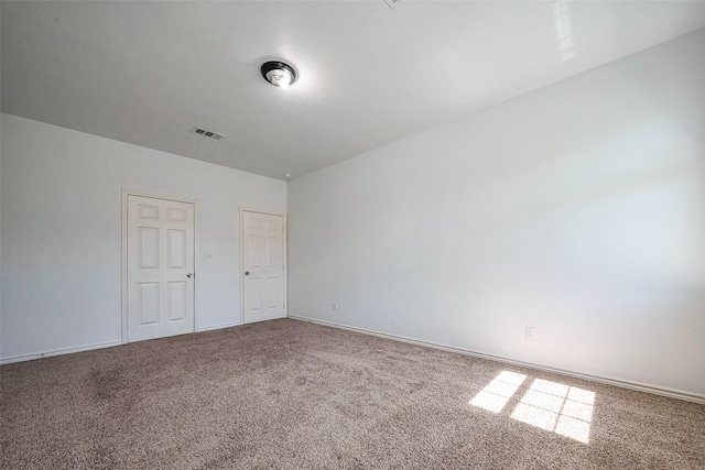 unfurnished bedroom with carpet floors and visible vents