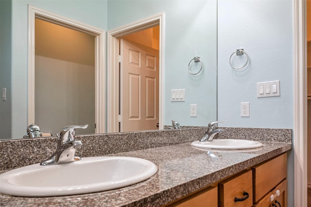 full bath with double vanity and a sink