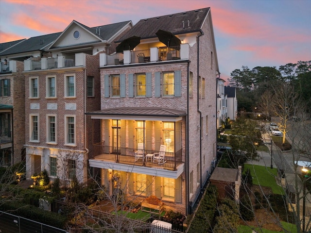 view of back of property at dusk