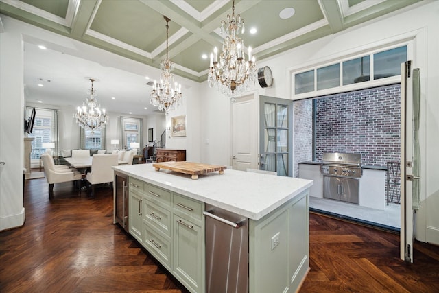 kitchen with coffered ceiling, open floor plan, a center island, a chandelier, and pendant lighting