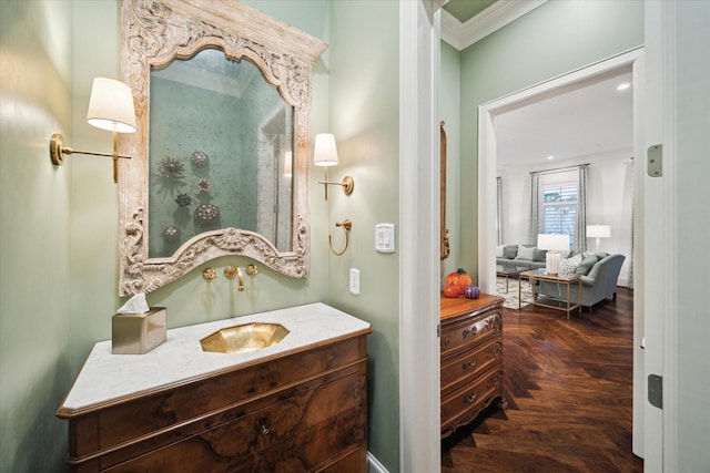 bathroom with ornamental molding and vanity