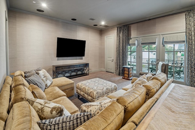 living area with recessed lighting, visible vents, crown molding, and wood finished floors