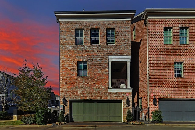 view of front of house with concrete driveway, brick siding, and an attached garage