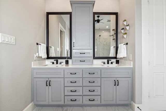 full bathroom featuring a sink, marble finish floor, a shower stall, and double vanity