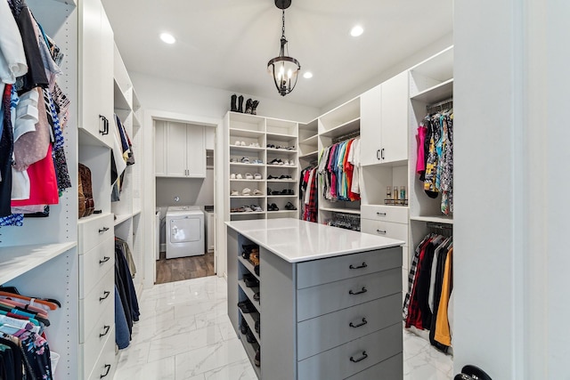 spacious closet with marble finish floor and washing machine and clothes dryer