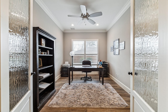 office featuring wood finished floors, visible vents, baseboards, ceiling fan, and crown molding