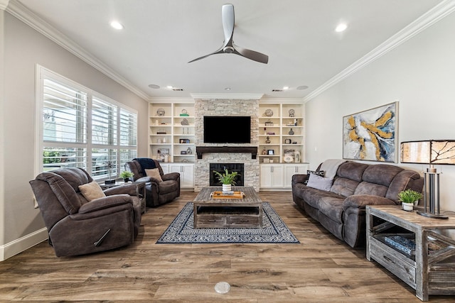 living room with a fireplace, crown molding, ceiling fan, and wood finished floors