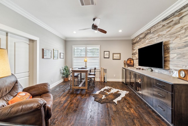 living area with visible vents, crown molding, baseboards, and dark wood-style flooring