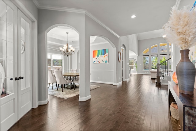 foyer entrance featuring ornamental molding, dark wood-style flooring, and baseboards