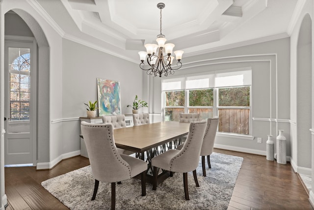 dining area featuring ornamental molding, arched walkways, dark wood finished floors, and plenty of natural light