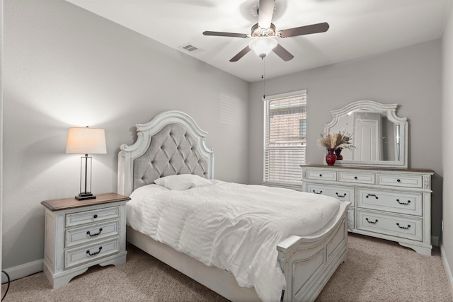 carpeted bedroom featuring ceiling fan and visible vents