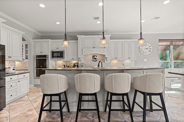 kitchen with white cabinets, visible vents, stainless steel appliances, and crown molding