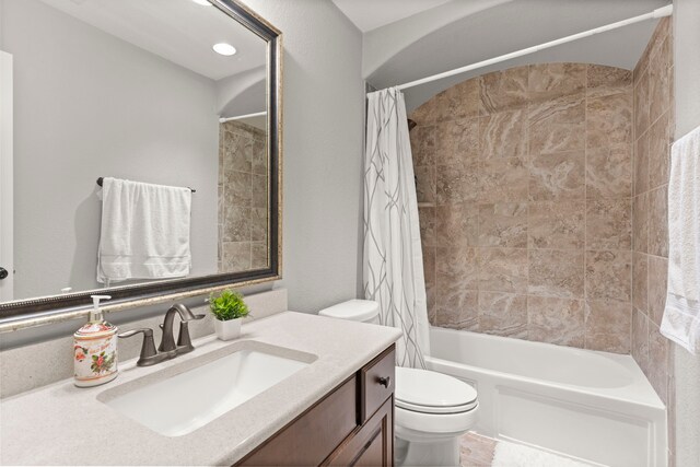 full bathroom with toilet, shower / bathtub combination with curtain, and vanity