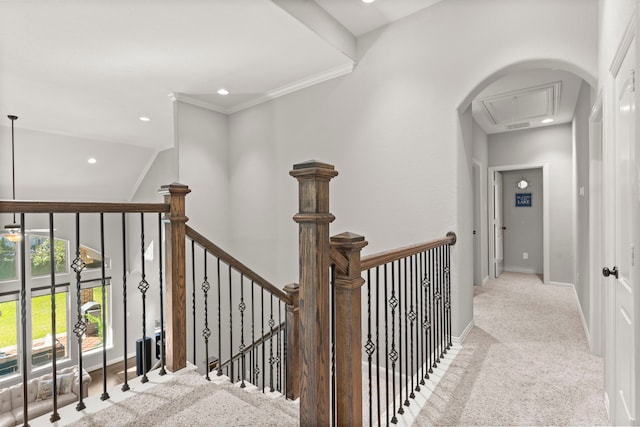 hallway featuring baseboards, lofted ceiling, ornamental molding, an upstairs landing, and carpet floors