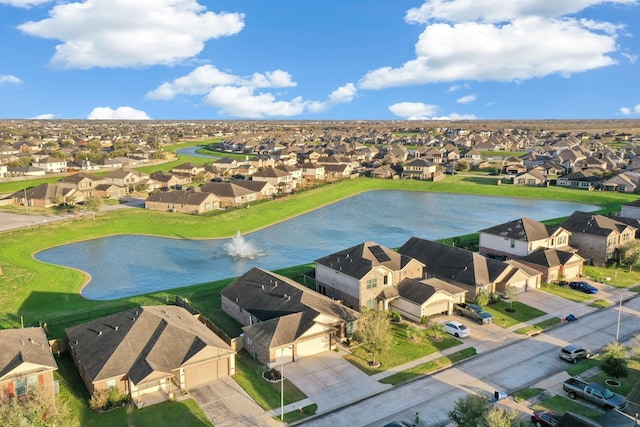 drone / aerial view with a water view and a residential view