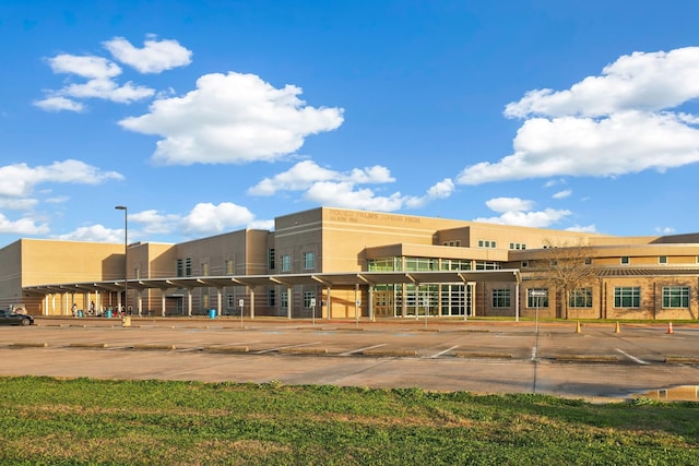 view of building exterior with uncovered parking