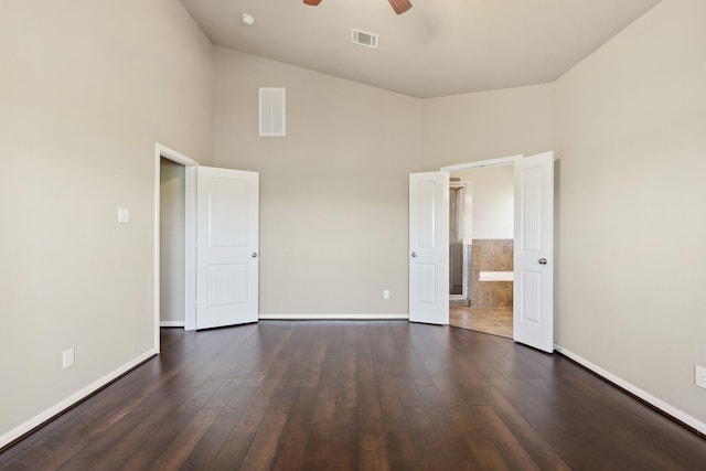 unfurnished bedroom featuring dark wood-style flooring, visible vents, and baseboards