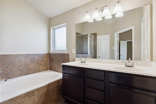 bathroom featuring double vanity, a garden tub, a shower stall, and a sink