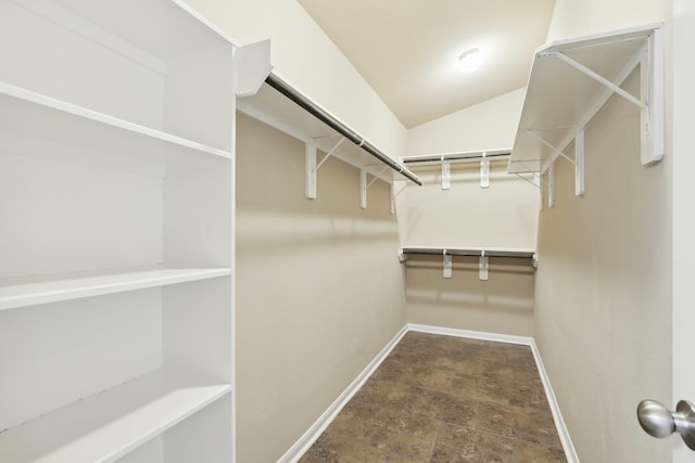 walk in closet with lofted ceiling