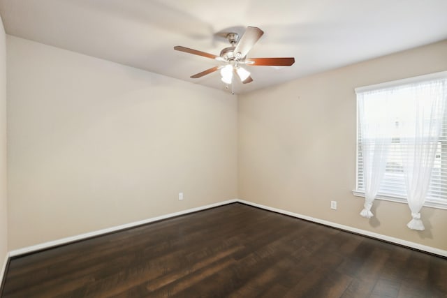 empty room with ceiling fan, baseboards, and dark wood-style flooring