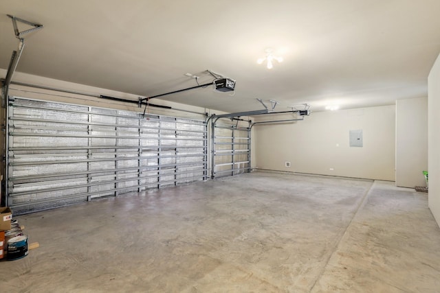 garage featuring electric panel and a garage door opener