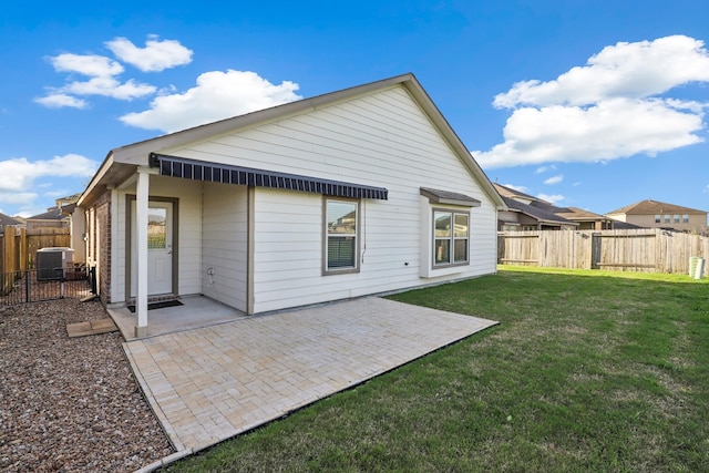 back of property with a yard, a patio, and a fenced backyard