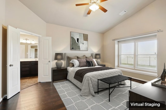 bedroom with visible vents, a ceiling fan, lofted ceiling, ensuite bath, and dark wood-type flooring