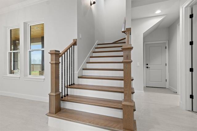 staircase featuring baseboards and recessed lighting